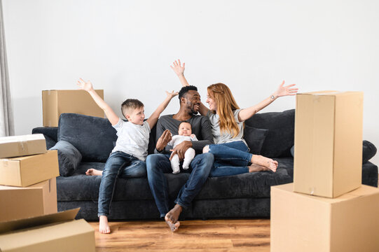 Happy family celebrating in their new permanent home after successful transition from temporary accommodation
