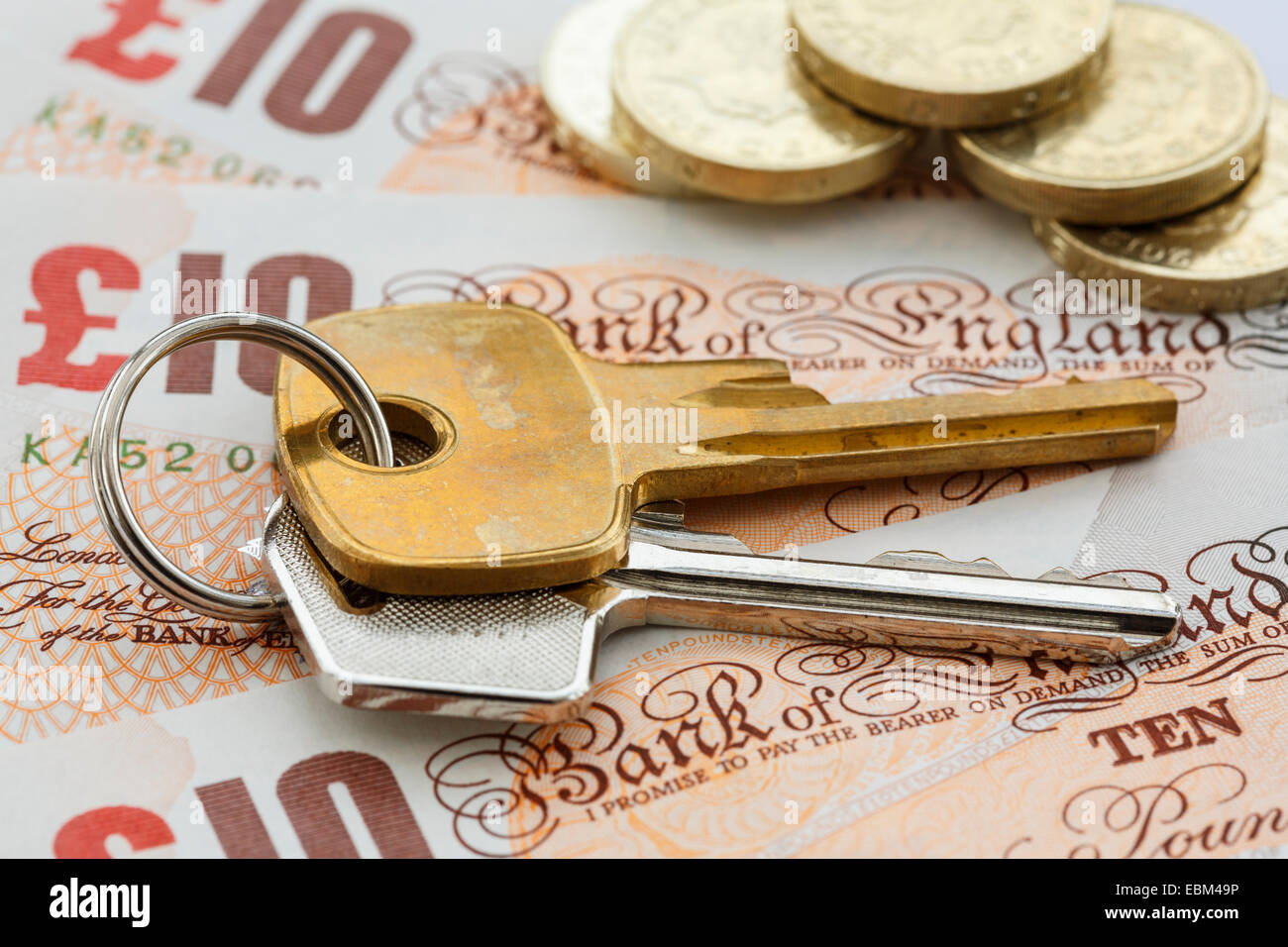House keys on UK pound sterling representing cost-effective housing solutions and financial benefits